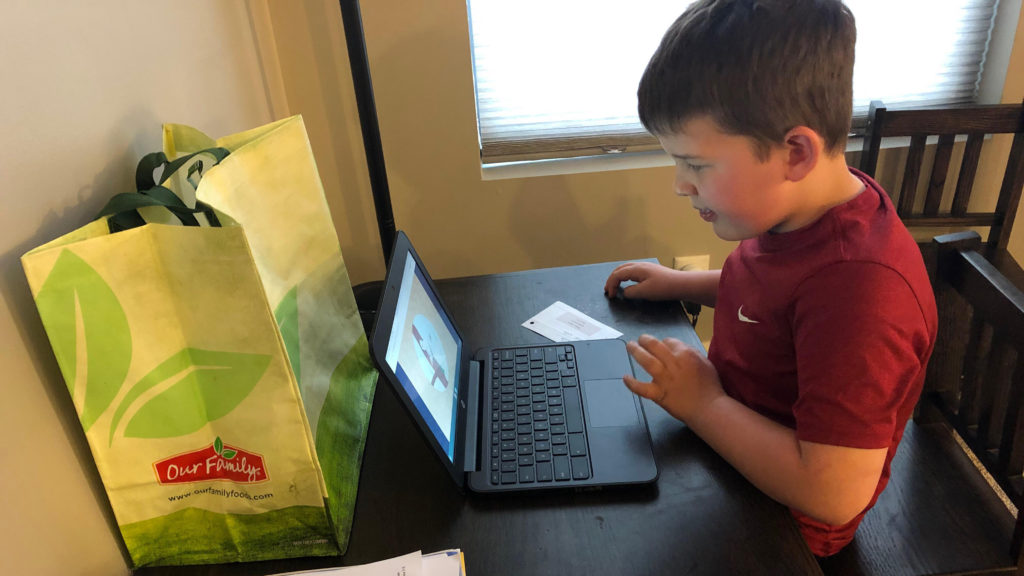 Boy working on homework on a computer